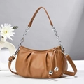 Detail of caramel pleated dumpling bag featuring silver chain handle and metal ball charms - L21 W24 H8 / Apricot
