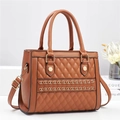 Detailed shot of brown quilted crossbody bag with gold chain and metal rivet accents - Earthy Yellow