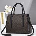 Close-up of brown monogram handbag with black handles and metallic zipper detail - L32 W14 H23 / Black Oval