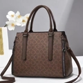 Detail view of brown leather handbag with chain print and decorative side zippers - L32 W14 H23 / Coffee Oval Monogram