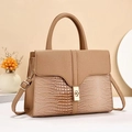 Detail of caramel crocodile pattern stitching and golden square lock on handbag - Khaki