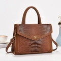 Detail of brown crocodile pattern handbag with always love you heart metal plate - Earthy Yellow