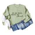 Flat lay of light green sweatshirt with it is well with my soul text and jeans - S / Olive Green (Black Font)