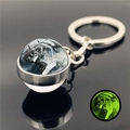 Luminous wolf keychain featuring a green glow-in-the-dark effect in dark settings - Grey Wolf in Snow Illustration (XSWX2748-16)