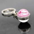 Detail of pink ribbon keychain with Breast Cancer Awareness Month text on dark mirror - Awareness Month Slogan (JY007298-14)
