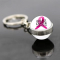 Close-up of glass pendant with pink ribbon and Breast Cancer Awareness Day text - Breast Cancer Awareness Day (JY007298-10)