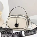 Cream-white crossbody bag with black trim, cat charm, and zig-zag pattern strap - Off White