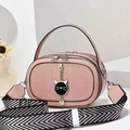 Pink pebbled leather handbag featuring cat charm and chevron pattern wide woven strap - Pink