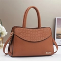 Detail of brown stone pattern embossing and gold metal logo on stylish tote bag - L30 W13 H20 / Earthy Yellow