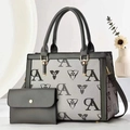 Detail of grey monogram printed tote bag and matching envelope pouch set on white decor - Gray