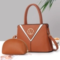 Detailed shot of brown lychee texture leather tote bag with V-logo and contrast V-stripes - Earthy Yellow