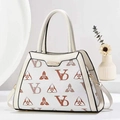 Macro view of beige crossbody bag with premium brown print pattern and golden clasp - Off White