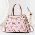Detail of pink floral monogram crossbody bag with golden zipper and leather handles - Pink