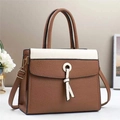 Detail of contrasting brown and beige leather handbag with tassel and gold hardware - 28x11x22cm / Earthy Yellow