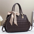 Detail of quilted dark chocolate shoulder bag with golden hardware and dotted silk scarf - Coffee