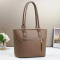 Close-up of brown lychee grain leather bucket bag with gold zipper and dual handles - Khaki