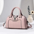 Detail of pink plaid Boston bag featuring a double-T metal clasp and round top handles - Taro Purple
