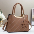 Brown quilted leather tote bag with elegant top handle and flower charm detail - Khaki