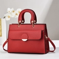 Detail of red lychee grain leather tote bag with gold hardware and top handle - Wine Red
