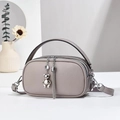 Detail of gray-purple crossbody bag with twin zippers and luxury tassel bear charm - 21x7x12cm / Light Gray
