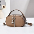 Detail of khaki round leather handbag with twin zippers and metal bear charm accessory - 21x7x12cm / Khaki