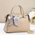 Detail of beige litchi grain leather bag with heart print scarf and golden hardware - Khaki