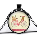 Close-up of vintage pink bicycle illustration in a black circular glass pendant - Pink Bike Flower Basket Paper Bag Style (JY007494-14)