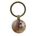 Close-up of vintage bronze keychain featuring a red bicycle and floral glass pendant - Jy007497-11