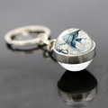 Macro shot of glass ball keychain featuring tropical fish, anchor, and vintage nautical map - Angelfish Anchor Style (JY007545-9)