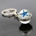 Macro shot of glass ball keychain featuring a starfish charm with silver metal keyring - Blue Starfish Style (JY007545-8)