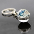 Macro shot of glass ball keychain with sailfish motif and vintage nautical map detail - Hand-painted Sailfish Style (JY007545-6)