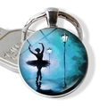 Macro view of a ballerina silhouette glass dome keychain with artistic blue night painting - Dancer Under Street Lamp Blue Night (JY007576-10)