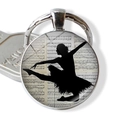 Close-up of ballet dancer silhouette keychain with vintage sheet music background - Vintage Staff Paper Dancer (JY007576-9)