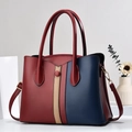 Detail view of tri-color patchwork tote bag featuring red blue beige PU leather texture - 29x12x22cm / Wine Red