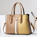 Detail showing the contrast patchwork panels and gold hardware on this chic tote bag - 29x12x22cm / Khaki