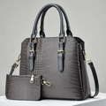Gray crocodile pattern tote and pouch set with gold hardware on a white stand - Gray