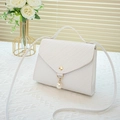 Minimalist white phone crossbody bag with pearl charm on elegant lace background - White