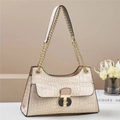 Detail of beige crocodile pattern handbag featuring a chic gold and black metal buckle lock - Khaki