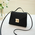 Elegant black woven small square handbag with golden twist lock and leather shoulder strap - Black