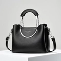 Minimalist black litchi pattern handbag with silver hardware on a geometric stand - Black