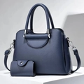 Dark blue pebbled leather tote bag set with detachable shoulder strap on white platform - Blue