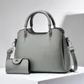 Gray lychee grain leather handbag set with matching pouch on minimalist stone base - Gray