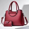 Detail of burgundy lychee leather handbag with matching coin purse and silver hardware - Wine Red