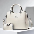 Detail of off-white lychee pattern leather tote bag set with silver hardware and shoulder strap - Off White