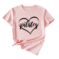 Close-up of pink Pilates T-shirt with black heart print and stylish front knot detail - Pink (Black Print)