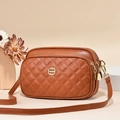 Quilted multi-layer crossbody bag in caramel brown with elegant golden ring logo - Earthy Yellow