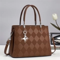 Detail of brown quilted faux leather handbag with silver hardware and star charm - Coffee