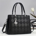 Quilted black leather tote bag with silver star pendant and adjustable shoulder strap - Black