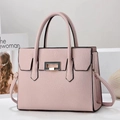 Detail of pink lychee leather tote bag with golden buckle and adjustable strap - Pink