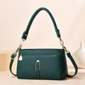 Detail of dark green lychee textured leather bag with gold hardware and wide handle - Green
